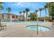 Outdoor swimming pool and spa area with shaded lounge areas and palm trees at 950 Seven Hills Dr # 1624, Henderson, NV 89052
