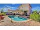 Backyard featuring a private pool, a covered patio area perfect for outdoor dining, and mature landscaping at 1025 Clover Tip Ct, Las Vegas, NV 89123