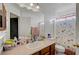Functional bathroom with vanity, large mirror, and shower with patterned curtain at 1025 Clover Tip Ct, Las Vegas, NV 89123