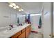 Bathroom featuring a long vanity with double sinks and a large mirror at 1025 Clover Tip Ct, Las Vegas, NV 89123