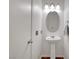 Small bathroom with white pedestal sink and framed oval mirror at 1025 Clover Tip Ct, Las Vegas, NV 89123