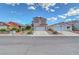 Exterior front view of a two-story home with a red tile roof, showcasing mature landscaping at 1025 Clover Tip Ct, Las Vegas, NV 89123