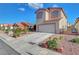 Exterior view of a two-story home with desert landscaping, a two-car garage, and a red tile roof at 1025 Clover Tip Ct, Las Vegas, NV 89123