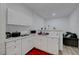 Compact kitchen with white cabinets, marble countertops, and modern appliances at 1025 Clover Tip Ct, Las Vegas, NV 89123