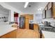 Bright kitchen with wood cabinets, stainless steel appliances, and laminate flooring at 1025 Clover Tip Ct, Las Vegas, NV 89123