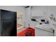 Small kitchen with white cabinetry and view to washer dryer room at 1025 Clover Tip Ct, Las Vegas, NV 89123