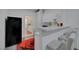 Small kitchen with white cabinetry, bar top, and adjacent seating area at 1025 Clover Tip Ct, Las Vegas, NV 89123