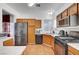 Functional kitchen with wood cabinets, stainless steel refrigerator, and modern appliances at 1025 Clover Tip Ct, Las Vegas, NV 89123