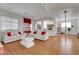Spacious living room with wood floors, white sofas, bright natural light, and high ceilings at 1025 Clover Tip Ct, Las Vegas, NV 89123