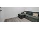 Cozy living area with gray sectional sofa and wood laminate flooring at 1025 Clover Tip Ct, Las Vegas, NV 89123
