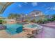 Backyard features a refreshing pool and spa, surrounded by lush landscaping and a private fence at 1025 Clover Tip Ct, Las Vegas, NV 89123