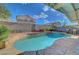 Gorgeous inground pool and spa surrounded by lush greenery and stone accents, perfect for relaxation at 1025 Clover Tip Ct, Las Vegas, NV 89123