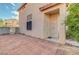 Side entrance featuring a brick-paved area, security gate, and desert landscaping at 1025 Clover Tip Ct, Las Vegas, NV 89123
