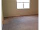 Bedroom featuring window and beige carpet at 10371 Calypso Cave St, Las Vegas, NV 89141