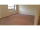 Neutral bedroom featuring soft carpet and natural light, creating a relaxing and inviting space at 10371 Calypso Cave St, Las Vegas, NV 89141