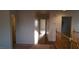 Upstairs hallway with a hardwood transition, showcasing well-lit, seamless passage to rooms on the second floor at 10371 Calypso Cave St, Las Vegas, NV 89141
