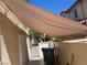 Enclosed backyard featuring a covered patio, secure gate, and mature trees for shade and privacy at 1069 Coronado Peak Ave, Las Vegas, NV 89183