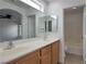 Bright bathroom featuring double sinks, a large mirror, and a separate room with a tub and toilet at 1069 Coronado Peak Ave, Las Vegas, NV 89183