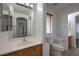 Bathroom with single vanity and mirror, toilet, and window at 1069 Coronado Peak Ave, Las Vegas, NV 89183