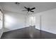 A bedroom with hardwood floors, freshly-painted walls, and multiple closet and bathroom access at 1069 Coronado Peak Ave, Las Vegas, NV 89183
