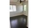 Bedroom with hardwood floors, windows, ceiling fan, base trim, and neutral paint at 1069 Coronado Peak Ave, Las Vegas, NV 89183