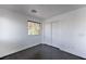 Bedroom with wood-look floors, closet doors, and natural light from a window at 1069 Coronado Peak Ave, Las Vegas, NV 89183