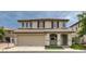 Charming two-story home with a tile roof, arched entryway, and manicured landscaping at 1069 Coronado Peak Ave, Las Vegas, NV 89183