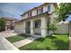 Inviting home exterior showcasing an arched porch, two stories, and a well-maintained front yard at 1069 Coronado Peak Ave, Las Vegas, NV 89183