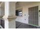 Covered front porch with textured columns, a security door, and a window to the side at 1069 Coronado Peak Ave, Las Vegas, NV 89183