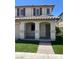 Charming two-story home with a covered porch and low-maintenance artificial turf in the front yard at 1069 Coronado Peak Ave, Las Vegas, NV 89183