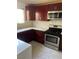 Kitchen featuring stainless steel appliances, cherry wood cabinets, marble countertops, and tiled flooring at 1069 Coronado Peak Ave, Las Vegas, NV 89183