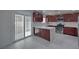 Bright kitchen featuring sliding glass doors, wood cabinets, quartz countertops, and modern appliances at 1069 Coronado Peak Ave, Las Vegas, NV 89183