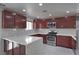 Well-equipped kitchen featuring wood cabinets, stainless steel appliances, and quartz countertops at 1069 Coronado Peak Ave, Las Vegas, NV 89183