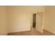 A neutral-toned bedroom with carpeted floors and an open door at 1325 Fiesta Grande Ct, North Las Vegas, NV 89031