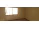 Simple bedroom featuring a window providing natural light at 1325 Fiesta Grande Ct, North Las Vegas, NV 89031
