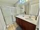 Well-maintained bathroom with double vanity, ample counter space, and glass-enclosed shower at 1355 Grass Creek Ave # 1, Henderson, NV 89012