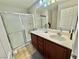 Well-lit bathroom featuring a shower, vanity with sink, and a clean modern design at 1355 Grass Creek Ave # 1, Henderson, NV 89012