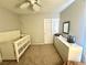 Cozy bedroom featuring a crib, dresser, and ceiling fan, perfect for a Bedroom at 1355 Grass Creek Ave # 1, Henderson, NV 89012