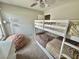 A cozy bedroom featuring bunk beds, natural light from the windows, and neutral carpet at 1355 Grass Creek Ave # 1, Henderson, NV 89012