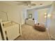 Well-lit bedroom with a crib, dresser, ceiling fan and comfortable bean bag at 1355 Grass Creek Ave # 1, Henderson, NV 89012