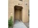 Close-up of entryway to a stucco home, featuring a door marked with the number '1' at 1355 Grass Creek Ave # 1, Henderson, NV 89012
