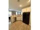 Spacious kitchen features stainless steel dishwasher and black refrigerator at 1355 Grass Creek Ave # 1, Henderson, NV 89012