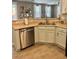 The kitchen area features a stainless steel dishwasher and view into living room at 1355 Grass Creek Ave # 1, Henderson, NV 89012