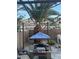 Cozy patio area featuring a string of lights, shade structure and landscaping offering an inviting outdoor space at 1355 Grass Creek Ave # 1, Henderson, NV 89012