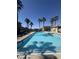 Inviting community pool, with palm trees and lounge chairs, perfect for relaxation and enjoyment under the sun at 1355 Grass Creek Ave # 1, Henderson, NV 89012