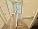 Carpeted staircase featuring white railing leading to the upper level with multiple doors and an open landing area at 1355 Grass Creek Ave # 1, Henderson, NV 89012