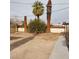 Expansive backyard featuring mature landscaping including palm trees and a partial block wall at 1413 Bryn Mawr Ave, Las Vegas, NV 89102