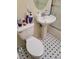 Compact bathroom shows a pedestal sink and tiled floor for practical use at 1413 Bryn Mawr Ave, Las Vegas, NV 89102