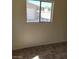 A bright bedroom featuring neutral paint and plush carpeting, illuminated by a window overlooking garage at 1413 Bryn Mawr Ave, Las Vegas, NV 89102