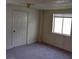 A bright bedroom featuring neutral paint and plush carpeting, illuminated by a window at 1413 Bryn Mawr Ave, Las Vegas, NV 89102